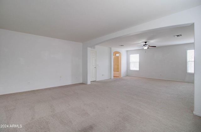 5659 S 239th Dr, Buckeye, AZ 85326 - carpeted spare room featuring a wealth of natural light, arched walkways, visible vents, and a ceiling fan