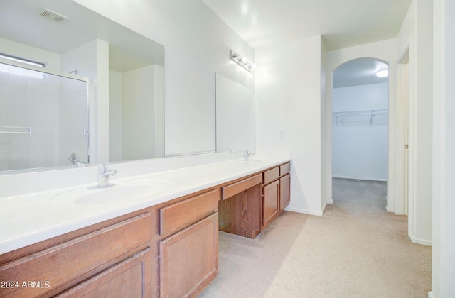 5659 S 239th Dr, Buckeye, AZ 85326 - bathroom with visible vents, a sink, an enclosed shower, double vanity, and a walk in closet
