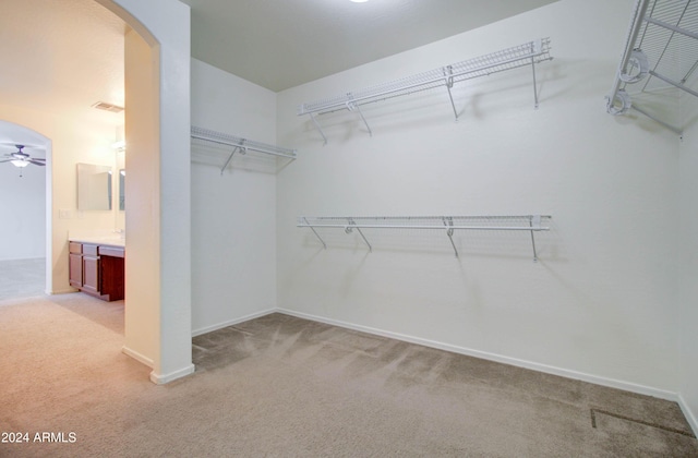5659 S 239th Dr, Buckeye, AZ 85326 - spacious closet featuring arched walkways, light colored carpet, a ceiling fan, and visible vents