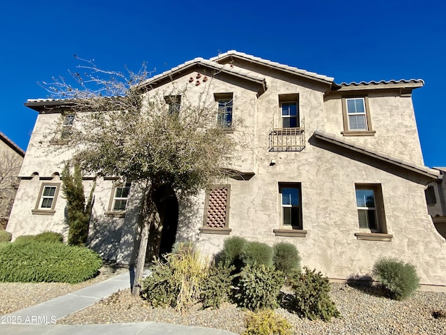 view of front of home with a tiled roof and stucco siding