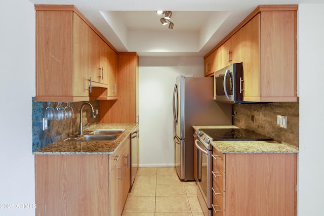 7350 N Via Paseo Del Sur Unit N207, Scottsdale, AZ 85258 - kitchen featuring appliances with stainless steel finishes, a sink, backsplash, and light stone counters