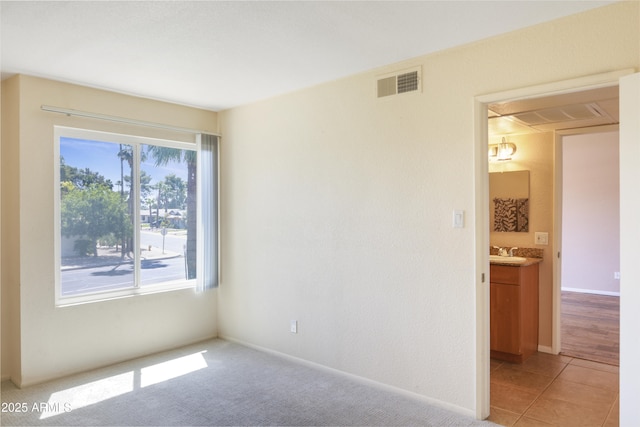 7350 N Via Paseo Del Sur Unit N207, Scottsdale, AZ 85258 - empty room featuring a sink and baseboards