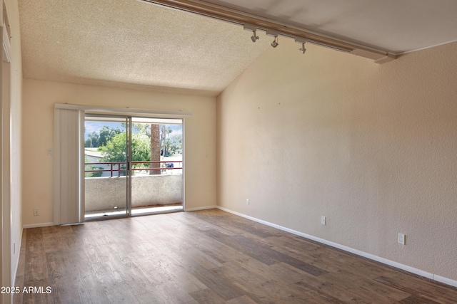 7350 N Via Paseo Del Sur Unit N207, Scottsdale, AZ 85258 - spare room featuring wood finished floors, rail lighting, baseboards, a textured wall, and a textured ceiling