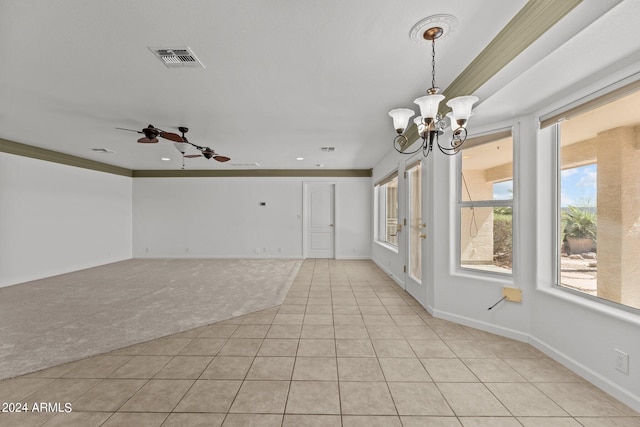 empty room featuring ceiling fan with notable chandelier, ornamental molding, and light tile patterned floors