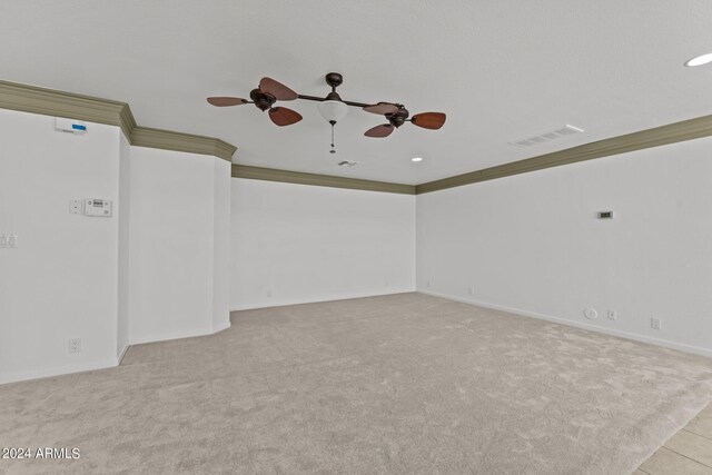 carpeted spare room with ornamental molding and ceiling fan