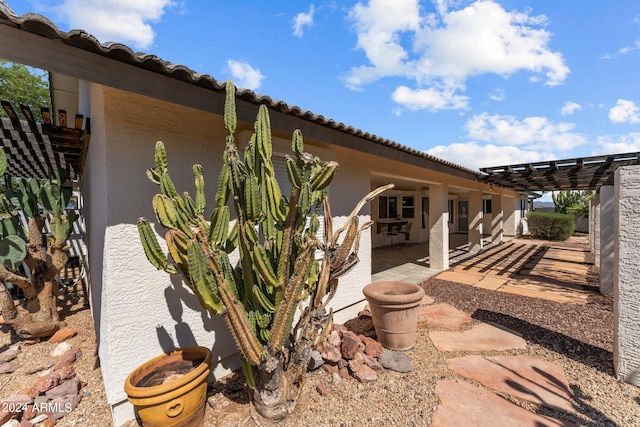 view of side of home with a pergola and a patio