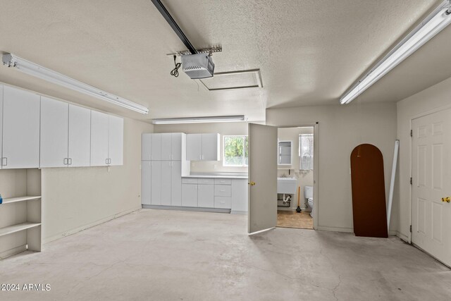 garage featuring a garage door opener and sink