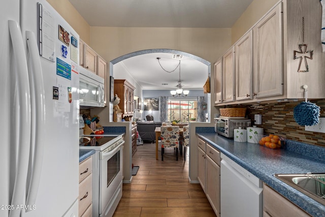 kitchen with light brown cabinetry, white appliances, wood-type flooring, and decorative backsplash