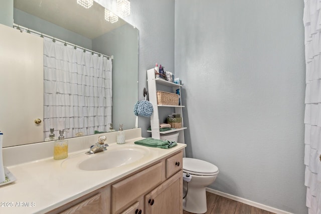 bathroom with hardwood / wood-style flooring, vanity, and toilet