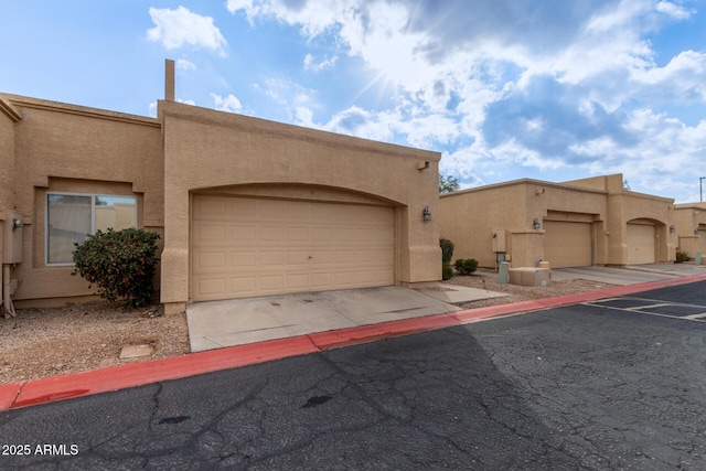 pueblo revival-style home with a garage