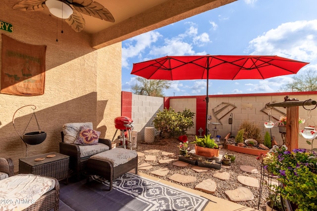 view of patio featuring ceiling fan