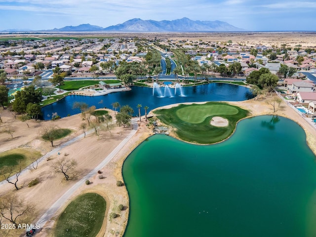 birds eye view of property with a water and mountain view