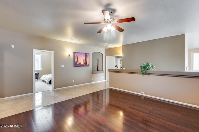 unfurnished room with ceiling fan and wood-type flooring