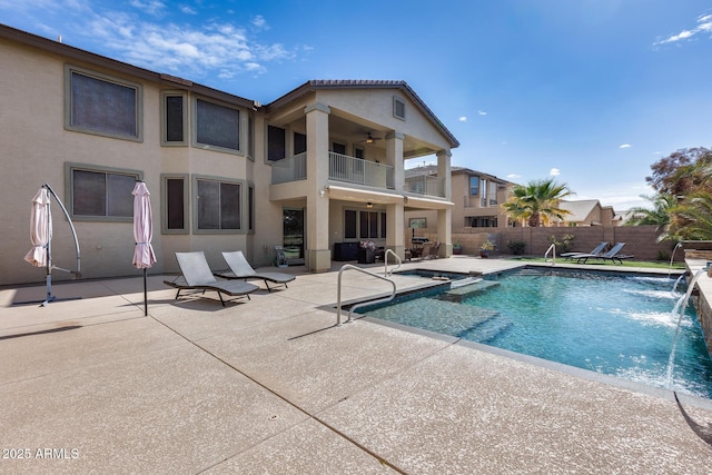 view of pool with a patio area and pool water feature