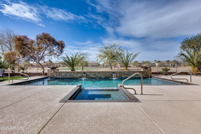 view of pool with a patio area, pool water feature, and an in ground hot tub