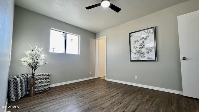 unfurnished bedroom with a ceiling fan, baseboards, and wood finished floors