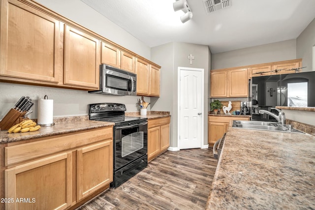 16917 W Sonora St, Goodyear, AZ 85338 - kitchen featuring black / electric stove, stainless steel microwave, dark wood-type flooring, light brown cabinetry, and light countertops