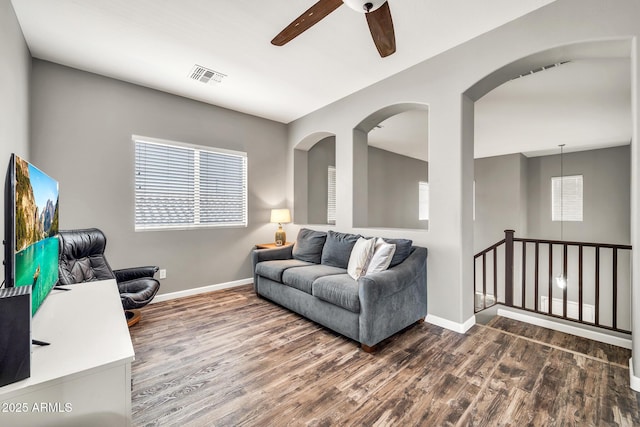 16917 W Sonora St, Goodyear, AZ 85338 - living room with a ceiling fan, dark wood-style flooring, and arched walkways