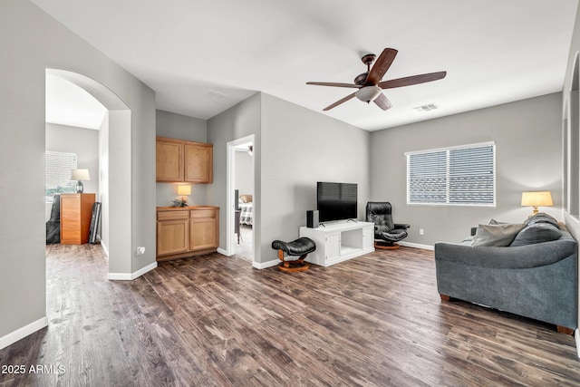 16917 W Sonora St, Goodyear, AZ 85338 - living room featuring dark wood-type flooring, a ceiling fan, and arched walkways