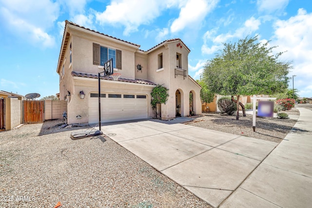 16917 W Sonora St, Goodyear, AZ 85338 - mediterranean / spanish-style house with an attached garage, stucco siding, a tile roof, concrete driveway, and a gate