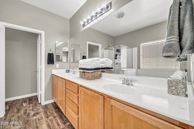 16917 W Sonora St, Goodyear, AZ 85338 - bathroom with double vanity, wood finished floors, and a stall shower