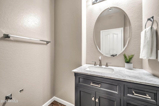 16917 W Sonora St, Goodyear, AZ 85338 - bathroom featuring vanity, a textured wall, and wood finished floors