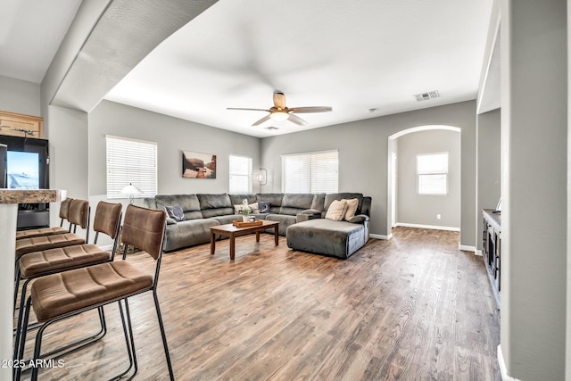 16917 W Sonora St, Goodyear, AZ 85338 - living area with a ceiling fan, wood finished floors, and arched walkways