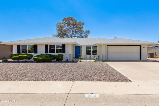 single story home with central AC and a garage