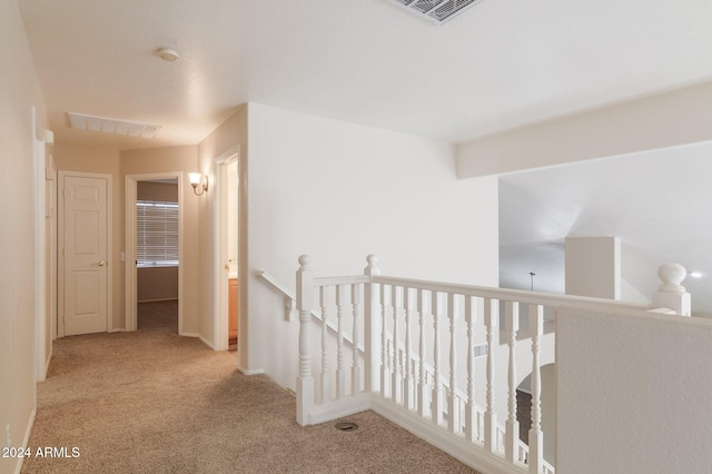 hallway with light carpet