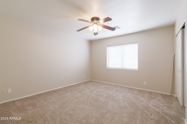 carpeted empty room with ceiling fan