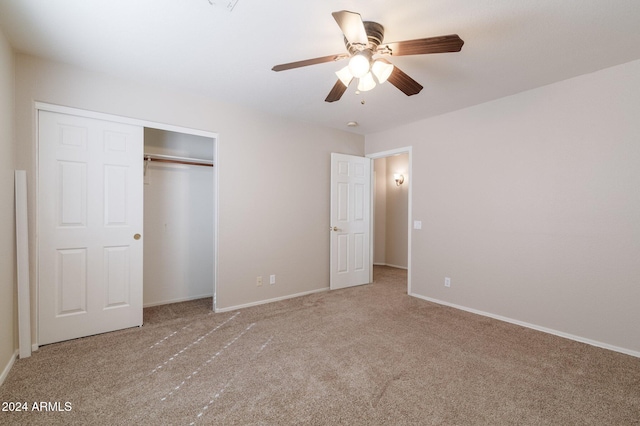 unfurnished bedroom with carpet, ceiling fan, and a closet