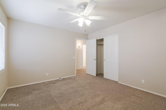 unfurnished bedroom featuring ceiling fan, a closet, and carpet floors