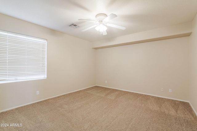 carpeted empty room featuring ceiling fan