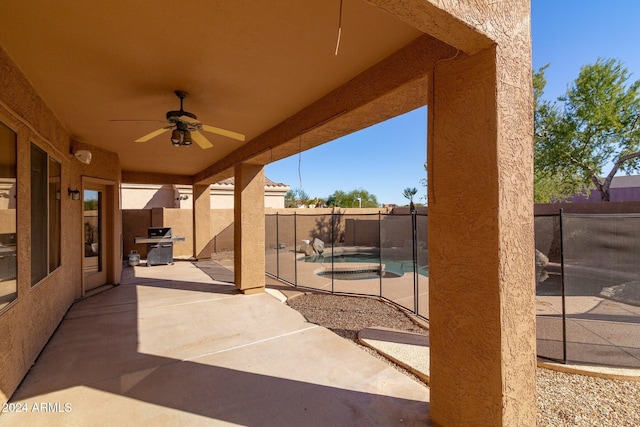 view of patio / terrace featuring a fenced in pool, area for grilling, and ceiling fan