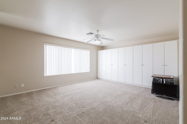 unfurnished bedroom featuring ceiling fan and light colored carpet