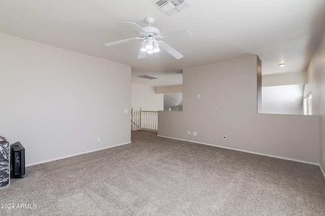 carpeted spare room with ceiling fan