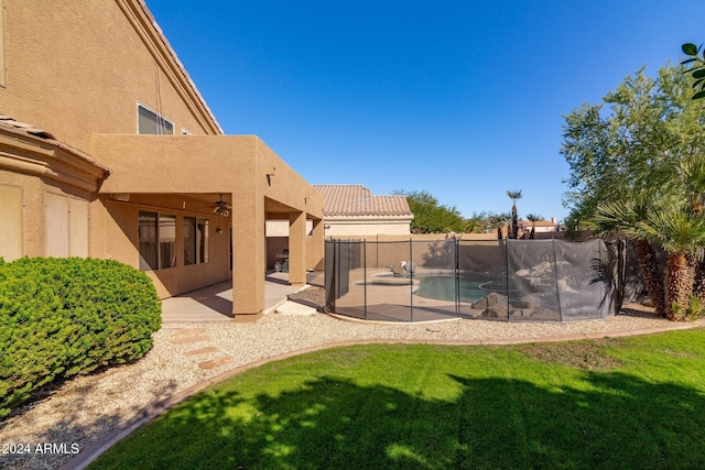 exterior space with a fenced in pool, a balcony, and a patio