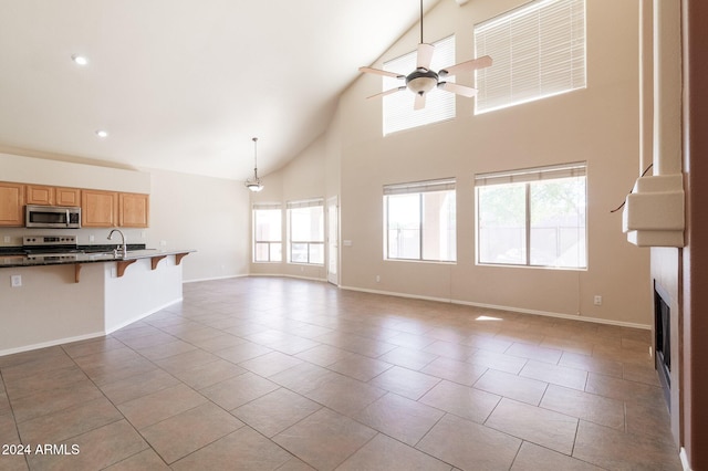 16847 S 13th Way, Phoenix, AZ 85048 - unfurnished living room with ceiling fan, high vaulted ceiling, tile patterned flooring, a sink, and a fireplace