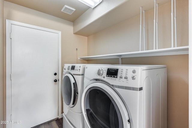 clothes washing area featuring laundry area, washing machine and dryer, and visible vents