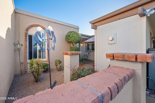 exterior space featuring a patio area and stucco siding