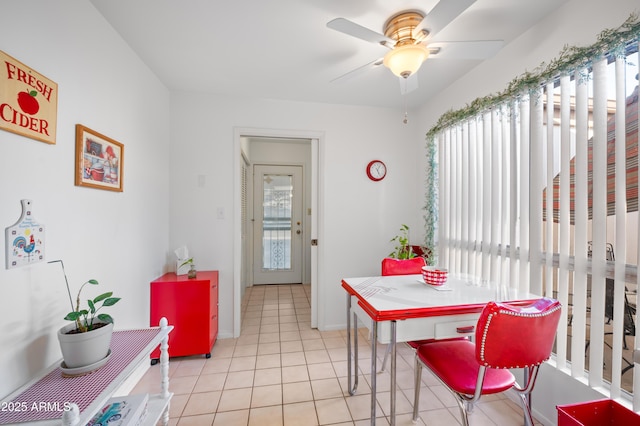 dining area with ceiling fan, light tile patterned flooring, and baseboards