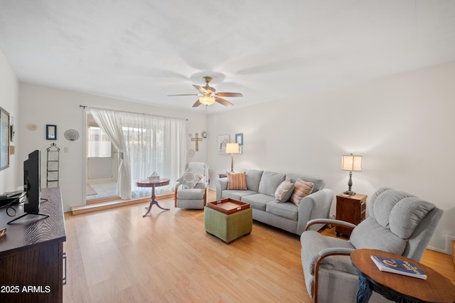 living room with light wood-style floors and a ceiling fan