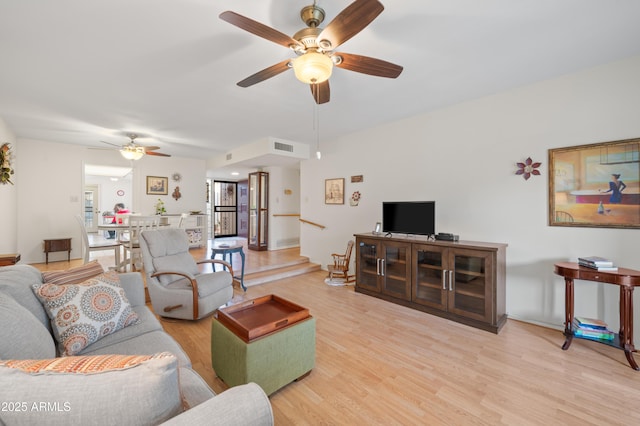 living area featuring ceiling fan, visible vents, and wood finished floors