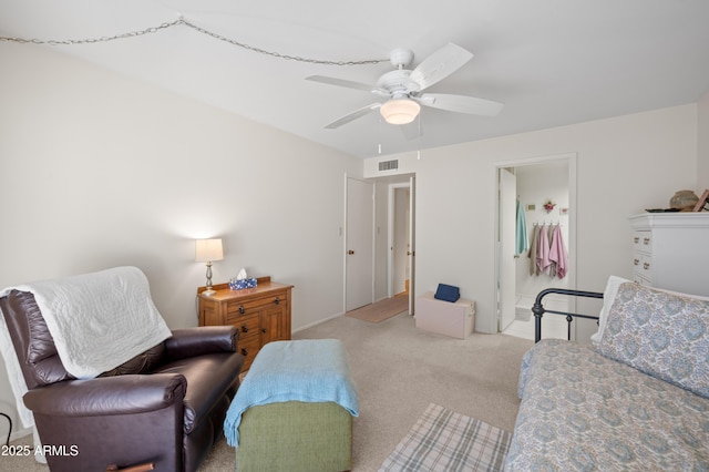 sitting room with a ceiling fan, carpet, and visible vents