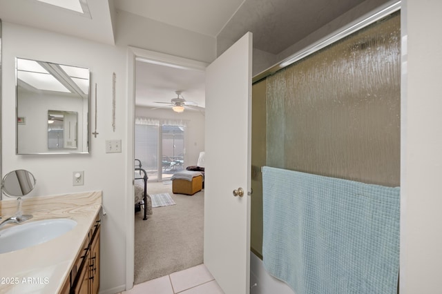 ensuite bathroom featuring ensuite bathroom, ceiling fan, vanity, tile patterned flooring, and walk in shower