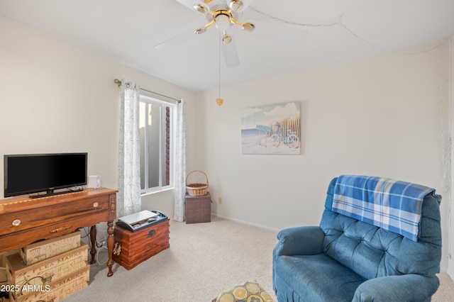 sitting room with carpet, ceiling fan, and baseboards