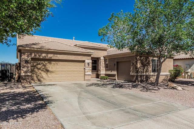 26264 N 74th Ln, Peoria, AZ 85383 - view of front of home with a tile roof, stucco siding, a garage, concrete driveway, and stone siding