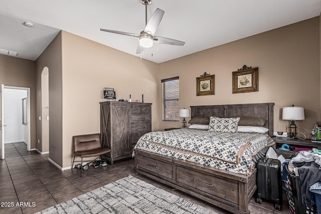 26264 N 74th Ln, Peoria, AZ 85383 - bedroom featuring arched walkways, dark tile patterned floors, baseboards, and ceiling fan