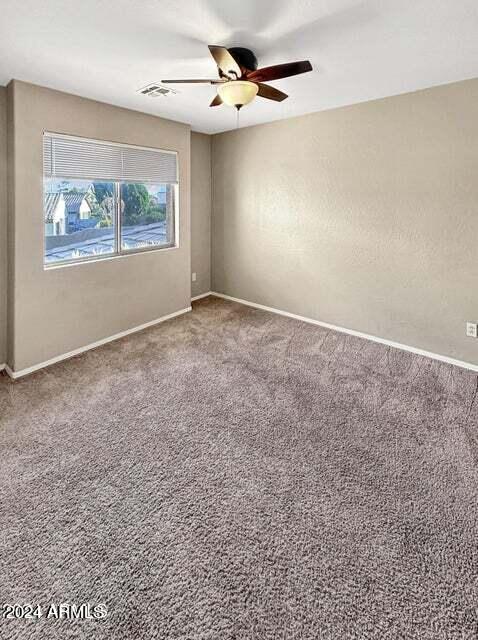 carpeted empty room with ceiling fan