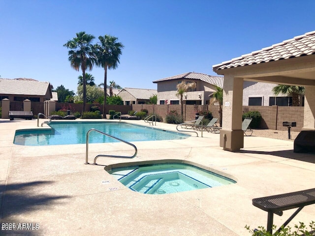 view of pool with a patio area and a hot tub